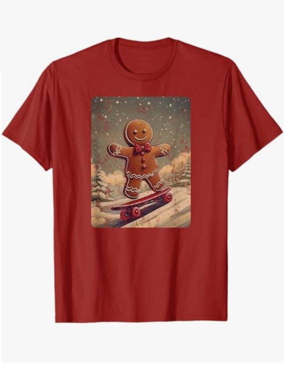 Christmas gingerbread man on a skateboard skating down a snowy winter hill. Distressed t-shirt graphic on a red shirt sleeve shirt.